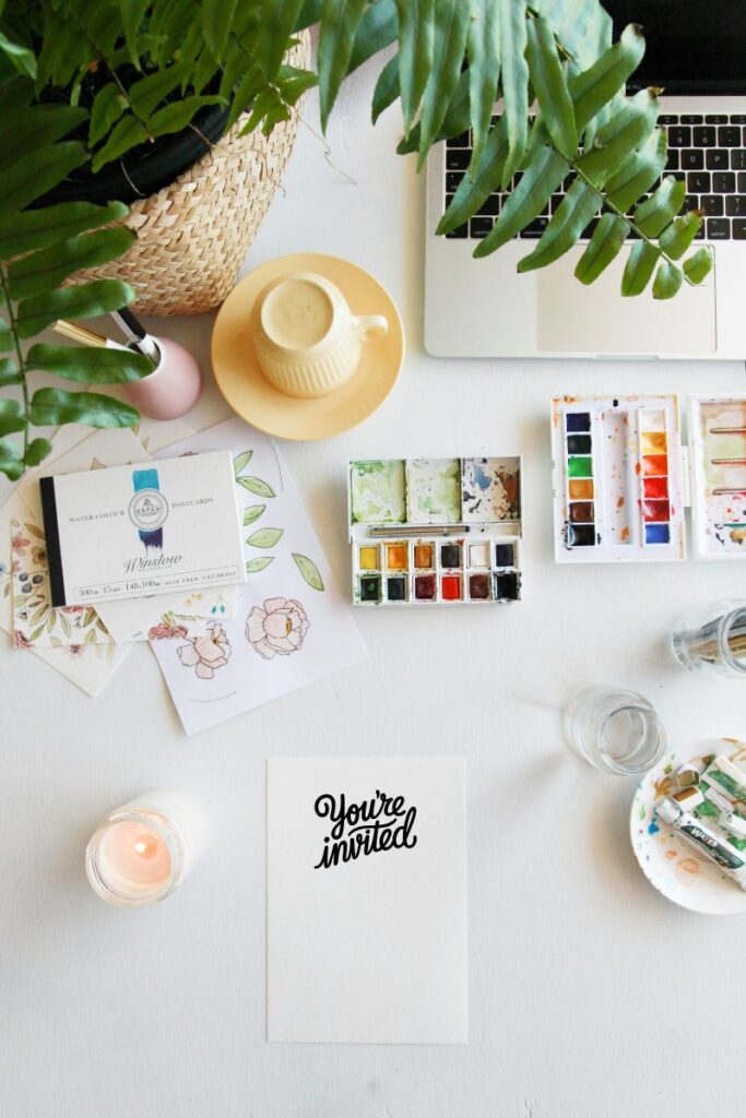 content creators desk with etsy products and watercolors